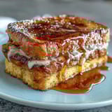 A golden, moist Southern-style cornbread baked in a cast-iron skillet, served warm with luscious honey butter for the ultimate comfort food experience.