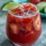 Vibrant Dragon Drink Refresher with coconut milk, strawberries, and dragon fruit served over ice in clear glasses.