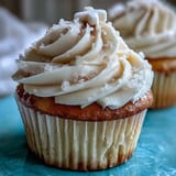 Soft vanilla communion cupcakes topped with fluffy buttercream and a pure white cross.