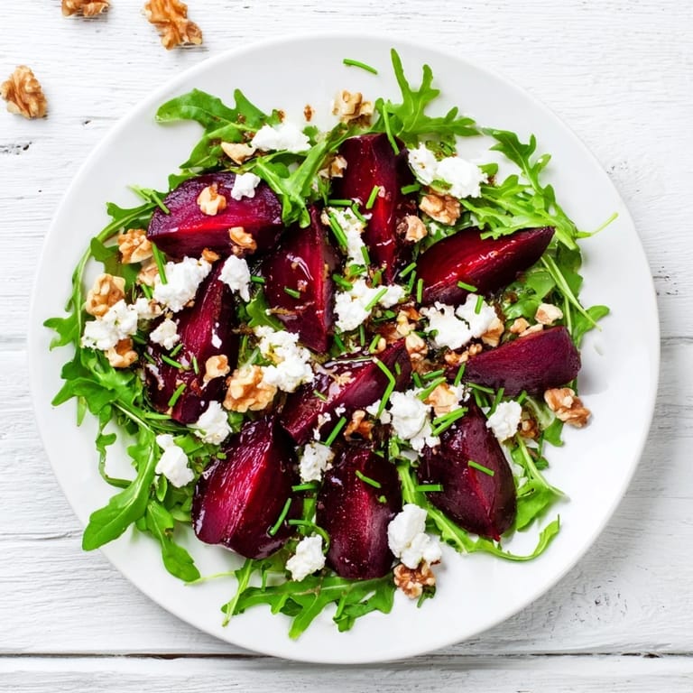 A vibrant roasted beet goat cheese salad with ruby beets, peppery arugula, and a bright balsamic vinaigrette.