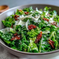 Bright arugula salad with lemon vinaigrette and shaved Parmesan, offering a tangy, peppery bite in every forkful.
